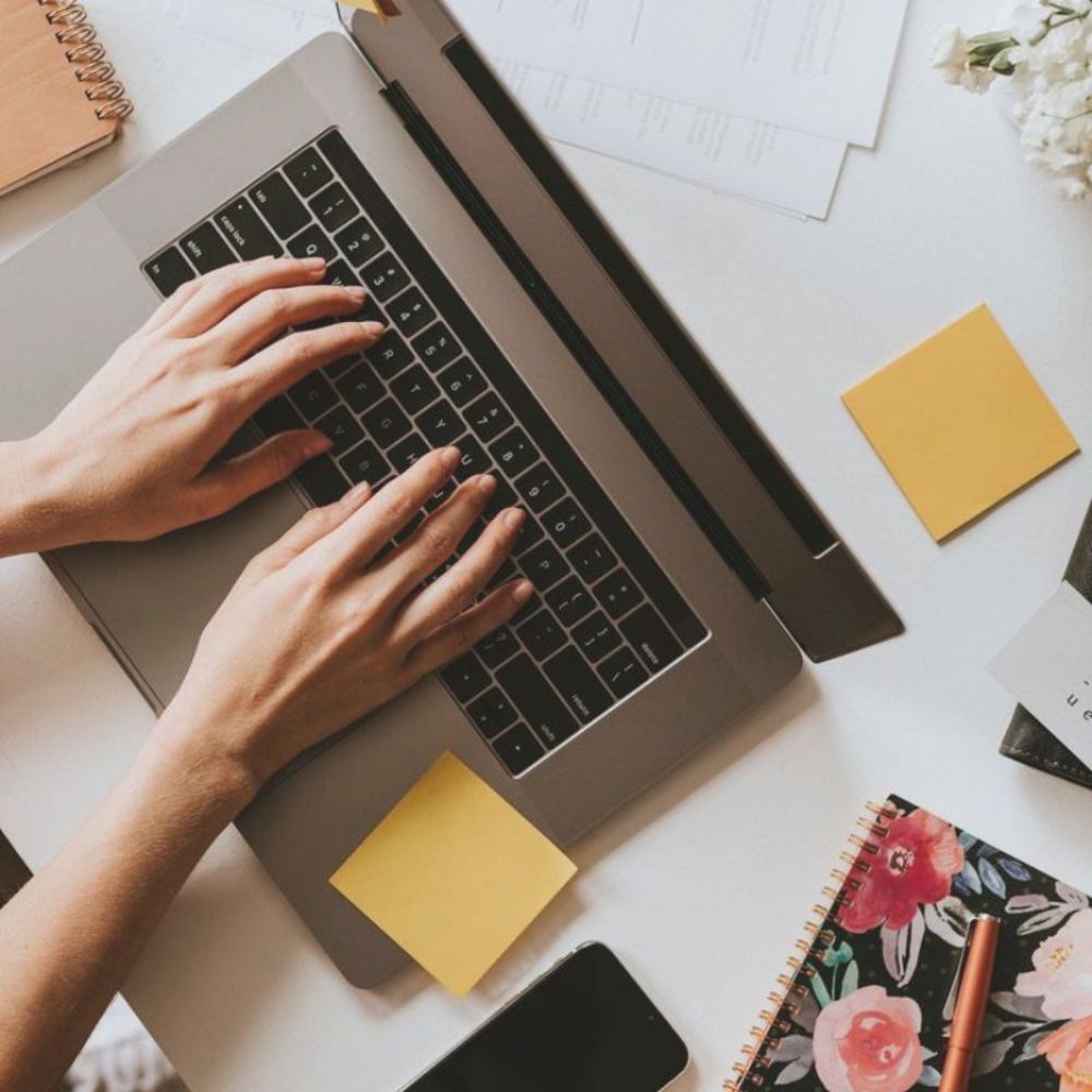 person typing on laptop